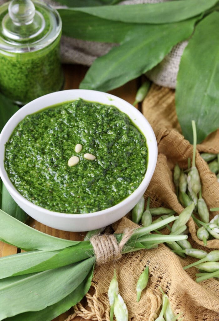 A small bowl full of freshly made pesto with wild garlic and toasted pine nuts.